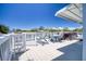 Inviting outdoor deck area featuring comfortable seating, a table, and a relaxing hot tub with lovely water view at 6629 Harbor Dr, Hudson, FL 34667