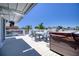 Relaxing outdoor deck area featuring comfortable seating, a table, and a hot tub with beautiful waterfront views at 6629 Harbor Dr, Hudson, FL 34667