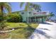 Charming green home with a large deck and beautifully landscaped front yard with a dock at 6629 Harbor Dr, Hudson, FL 34667