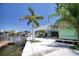 Elevated waterfront home with dock access and lush landscaping, providing a serene coastal setting at 6629 Harbor Dr, Hudson, FL 34667