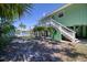 Beautiful exterior view of home with stairs, a lush yard, a water view, and an outdoor space at 6629 Harbor Dr, Hudson, FL 34667