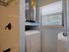 Functional laundry area and shower featuring a washing machine, dryer, and water heater at 6629 Harbor Dr, Hudson, FL 34667