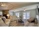 Bright living room featuring modern furniture, a stone fireplace, and views of the water at 6629 Harbor Dr, Hudson, FL 34667
