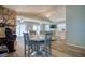 Open-concept living room featuring wood floors, stone fireplace, and access to outdoor deck at 6629 Harbor Dr, Hudson, FL 34667