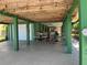 Spacious outdoor space with patio seating and under-house lighting for relaxing or entertaining at 6629 Harbor Dr, Hudson, FL 34667