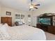 Main bedroom with backyard access and large TV at 5378 Legend Hills Ln, Spring Hill, FL 34609