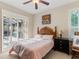 Bedroom with queen bed and access to the backyard at 5378 Legend Hills Ln, Spring Hill, FL 34609
