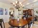 Spacious dining area with a round table, hutch, and large mirror reflecting light at 5378 Legend Hills Ln, Spring Hill, FL 34609