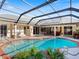 Relaxing pool area with covered lanai and lush landscaping at 5378 Legend Hills Ln, Spring Hill, FL 34609
