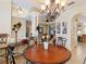 Elegant dining room features a round table, chandelier, and views into the living room at 5378 Legend Hills Ln, Spring Hill, FL 34609