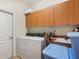 Laundry room with washer, dryer, and extra storage at 5378 Legend Hills Ln, Spring Hill, FL 34609