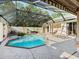 Screened pool and spa with patio furniture at 5378 Legend Hills Ln, Spring Hill, FL 34609