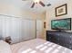 Bright bedroom with double closets and a TV at 5378 Legend Hills Ln, Spring Hill, FL 34609