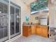 Outdoor kitchen with sink, mini-fridge, and grill at 5378 Legend Hills Ln, Spring Hill, FL 34609