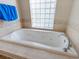 Relaxing bathtub with a glass block window for natural light at 5378 Legend Hills Ln, Spring Hill, FL 34609