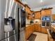 Modern kitchen features stainless steel appliances and wood cabinetry at 5378 Legend Hills Ln, Spring Hill, FL 34609
