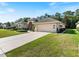 One-story house with attached garage and manicured lawn at 5378 Legend Hills Ln, Spring Hill, FL 34609