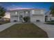 Two-story house with double garage and landscaping at 3407 Palometa Dr, Hernando Beach, FL 34607