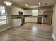 Modern kitchen with white cabinets, stainless steel appliances, and light grey flooring at 12368 Killian St, Spring Hill, FL 34609