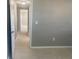 Clean hallway with neutral-toned walls and carpet at 13912 Sommers Ave, Hudson, FL 34667