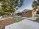 View of house exterior from the side, showing the sunroom and backyard at 13912 Sommers Ave, Hudson, FL 34667