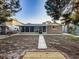 Home's exterior, featuring a sunroom and walkway to the canal at 13912 Sommers Ave, Hudson, FL 34667