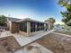 Side view of the house, highlighting the sunroom and landscaping at 13912 Sommers Ave, Hudson, FL 34667