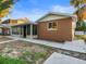 Another view of home's exterior, showcasing the sunroom and landscaping at 13912 Sommers Ave, Hudson, FL 34667