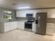 Modern kitchen with white cabinets and appliances at 13912 Sommers Ave, Hudson, FL 34667