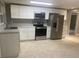 Modern kitchen with white cabinets and appliances at 13912 Sommers Ave, Hudson, FL 34667