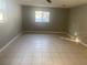 Bright living room with tile flooring and large window at 13912 Sommers Ave, Hudson, FL 34667