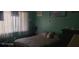 Bedroom with teal walls, a bed, and a window with curtains at 8210 Aquila St # 226, Port Richey, FL 34668