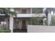 Condo building entrance with elevator access and lush landscaping at 8210 Aquila St # 226, Port Richey, FL 34668