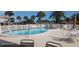 Relaxing kidney-shaped pool with lounge chairs at 8210 Aquila St # 226, Port Richey, FL 34668