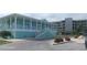 Exterior view of light teal building with white trim and stairs at 8210 Aquila St # 226, Port Richey, FL 34668