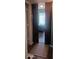 Hallway with barn door entry to bedroom, wood-look floors, and neutral walls at 8210 Aquila St # 226, Port Richey, FL 34668