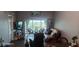 Living room with view of balcony, comfy seating, and large TV at 8210 Aquila St # 226, Port Richey, FL 34668