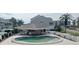 Kidney-shaped pool with covered patio and seating area at 8210 Aquila St # 226, Port Richey, FL 34668