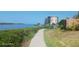 Scenic walkway along the waterfront with lush landscaping and condo building views at 8210 Aquila St # 226, Port Richey, FL 34668