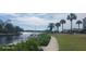 Peaceful waterfront walkway with boat docks and lush vegetation at 8210 Aquila St # 226, Port Richey, FL 34668