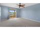 Bright bedroom featuring a ceiling fan and access to a private balcony at 3480 Croaker Dr, Hernando Beach, FL 34607