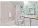 Well-lit bathroom with a bathtub and shower combo with pastel accents at 5537 Sea Forest Dr # 307, New Port Richey, FL 34652