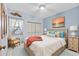 Cozy bedroom with blue accents, plush bed, and ample natural light at 5537 Sea Forest Dr # 307, New Port Richey, FL 34652