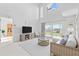 Bright living room with high ceilings, balcony, and stylish, comfortable furnishings at 5537 Sea Forest Dr # 307, New Port Richey, FL 34652