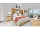 Comfortable main bedroom with a king bed, built-in storage, and private balcony at 5537 Sea Forest Dr # 307, New Port Richey, FL 34652