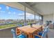 Relaxing screened patio with dining set and seating area boasts pleasant views at 5537 Sea Forest Dr # 307, New Port Richey, FL 34652