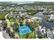Aerial view showing community tennis courts and waterfront homes at 5537 Sea Forest Dr # 307, New Port Richey, FL 34652
