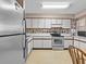 Efficient kitchen with white cabinets, stainless steel appliances at 5537 Sea Forest Dr # 307, New Port Richey, FL 34652