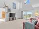 Spacious living room with high ceilings, balcony access, and city views at 5537 Sea Forest Dr # 307, New Port Richey, FL 34652