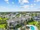 Aerial view of condo building near waterway, showcasing pool and landscape at 5537 Sea Forest Dr # 307, New Port Richey, FL 34652